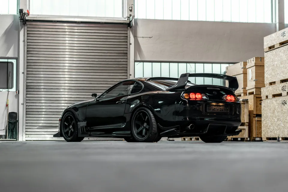 Чорна Toyota Supra в індустріальному гаражі — стокова фотографія